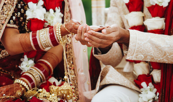 Hands of indian bride and groom intertwined together making auth Hands of indian bride and groom intertwined together making authentic wedding ritual